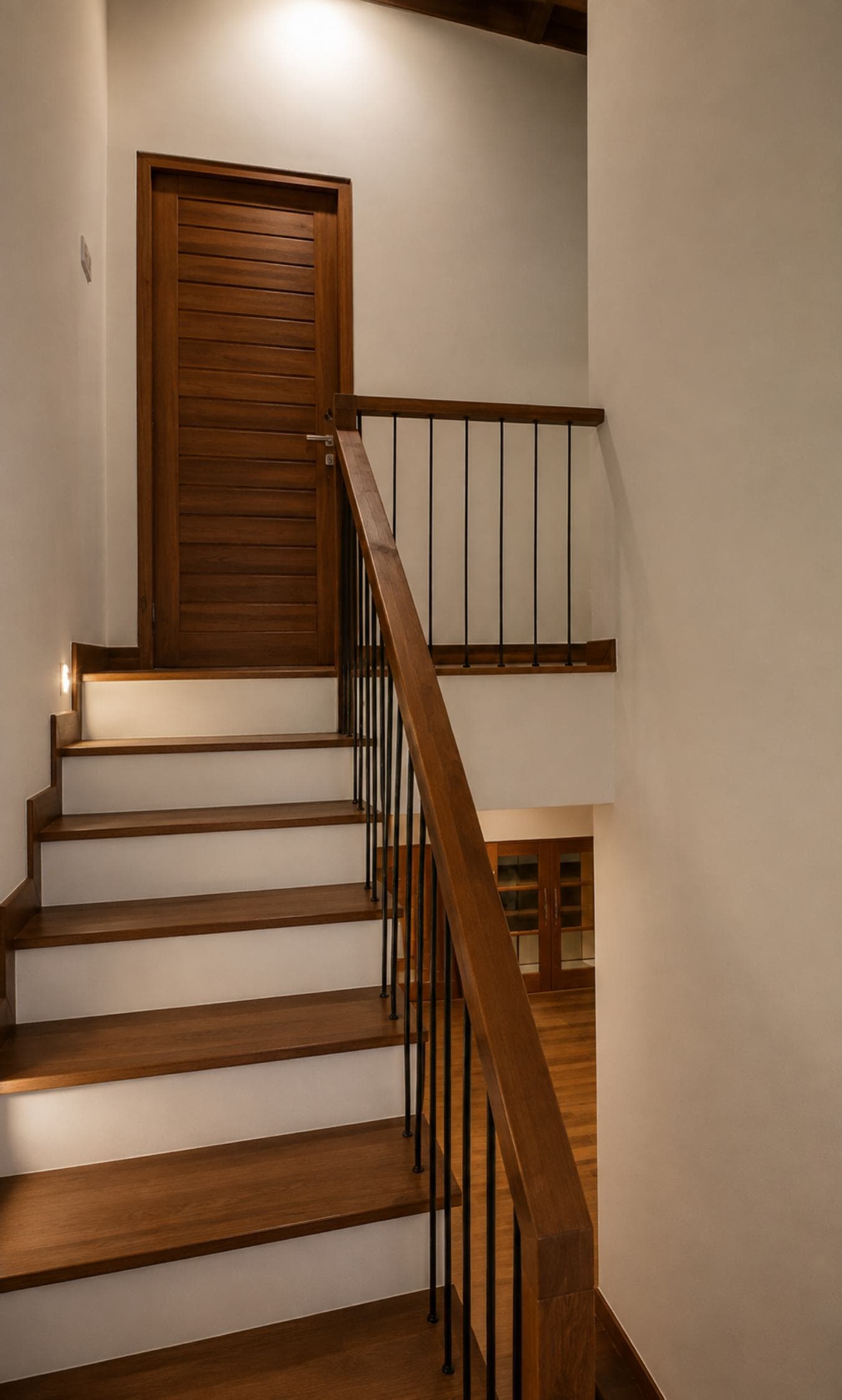 No. 11/11A, Saman Mawatha, Sirimal Uyana — timber stair with wrought-iron balusters up to a bedroom landing